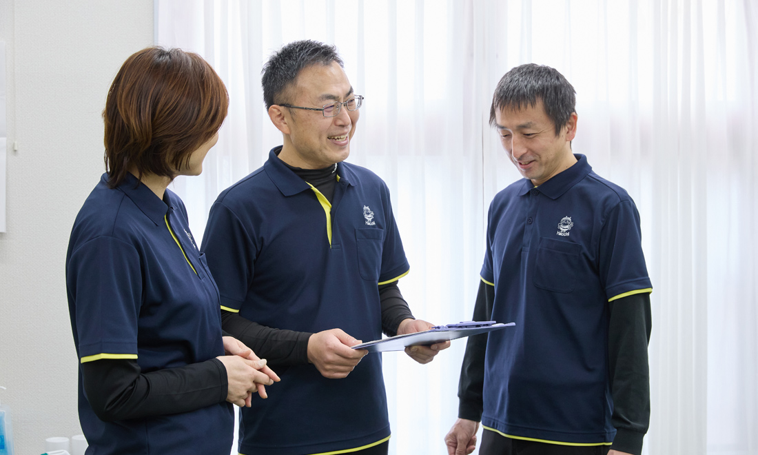 資料を見ながら打ち合わせをする株式会社アズのスタッフ